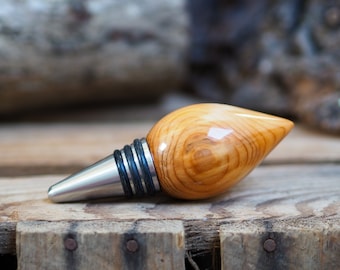 A premium bottle stopper made from a beautiful piece of Yew wood and Stainless steel. Wooden bottle stopper.