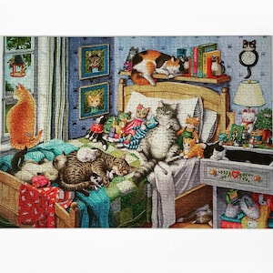 May include: A jigsaw puzzle depicting a bedroom scene filled with numerous cats of various colors and patterns. The cats are resting on a bed, a nightstand, and a shelf. The room features framed cat portraits, a lamp, and books.