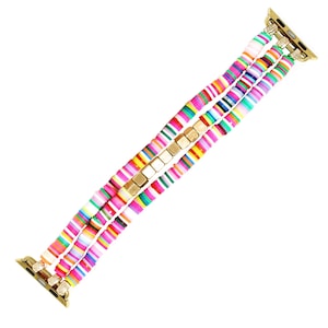 May include: A colorful Apple Watch band featuring a triple-strand design. The band is composed of flat, round, multicolored beads in shades of pink, green, yellow, and blue, interspersed with gold-toned metal accents. The band has gold-toned connectors.