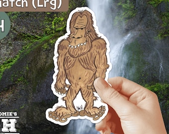 May include: A large, brown Sasquatch sticker with a white outline. The sticker is being held in a hand against a background of a waterfall and green foliage. The text "Sasquatch (Lrg)" and "$4" are visible in the image.
