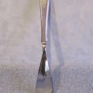 May include: Silver shoehorn with a fluted handle and the word "EBA" engraved on the handle.