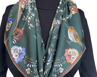May include: A green silk scarf with a floral and bird design. The scarf features a robin, a pheasant, and various flowers in shades of red, orange, yellow, blue, and white.