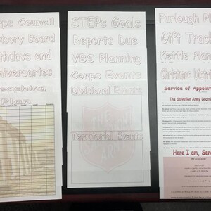 Puede incluir: Un tablero blanco con un logotipo rojo del Ejército de Salvación y texto que dice "Corps Council, Advisory Board, Birthdays and Anniversaries, Preaching Plan, STEPS Goals, Reports Due, VBS Planning, Corps Events, Divisional Events, Territorial Events, Furlough Plans, Gift Tracker, Kettle Planning, Christmas Distribution, Service of Appointments, The Salvation Army Doctrines, Here I am, Send Me".