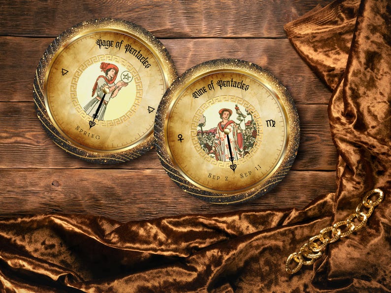 May include: Two round, antique-style tarot card designs with gold frames and illustrations of figures. The cards are set against a wooden background with a brown velvet cloth and a gold chain. The text on the cards reads "Page of Pentacles" and "Nine of Pentacles."