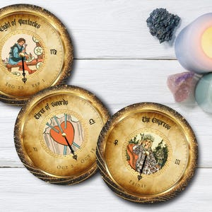 May include: Three round tarot card coasters with gold glitter rims. The coasters feature illustrations of the Eight of Pentacles, Three of Swords, and The Empress. Candles and crystals are in the background.