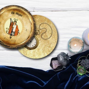 May include: A circular coaster with a tarot card design featuring "The Magus" and a pocket watch. The image includes lit candles, a velvet cloth, and decorative items. The coaster is approximately 4 inches in diameter.