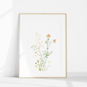 May include: A framed watercolor painting of a bouquet of wildflowers with orange, yellow, and green hues. The flowers are arranged in a simple, elegant style, and the painting is set against a white background.