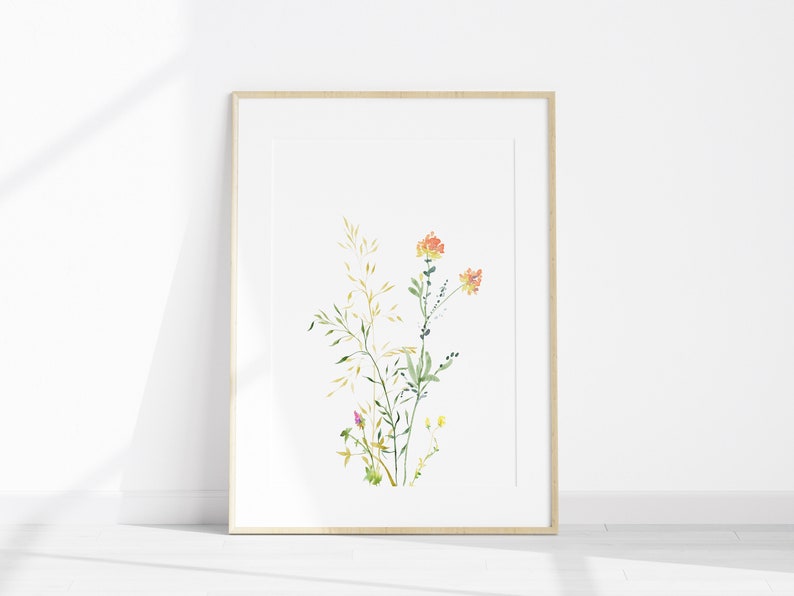 May include: A framed watercolor painting of a bouquet of wildflowers with orange, yellow, and green hues. The flowers are arranged in a simple, elegant style, and the painting is set against a white background.