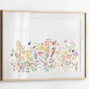 May include: A framed watercolor painting of a field of wildflowers in shades of pink, yellow, and purple. The flowers are arranged in a horizontal row across the bottom of the painting.