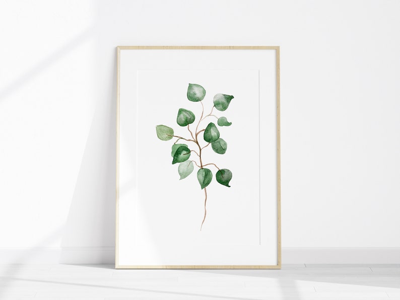 May include: A framed watercolor painting of a green leafy branch with a white background.