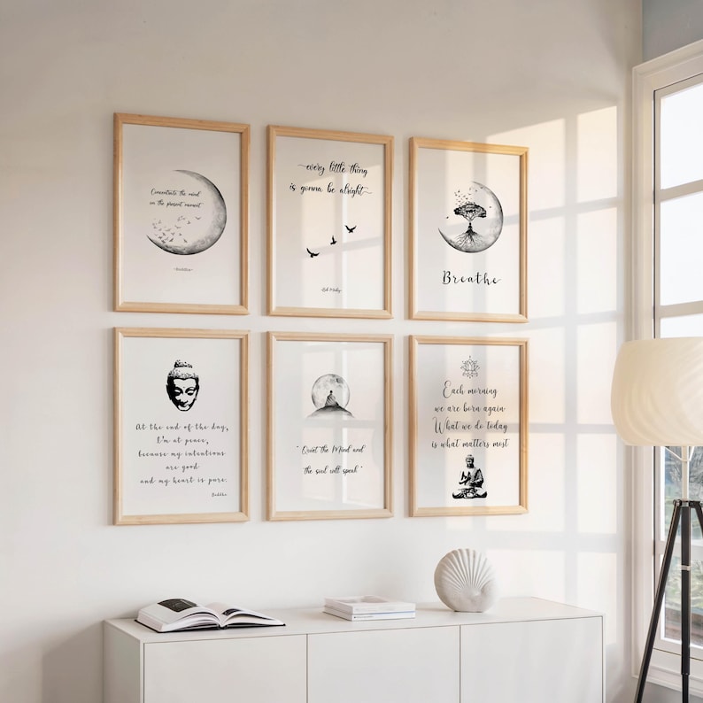 May include: Six framed art prints with inspirational quotes and minimalist illustrations. The prints feature images of a moon, birds, a tree, a Buddha, and a meditating figure. The frames are light wood.
