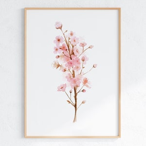 May include: A watercolor painting of a pink cherry blossom branch with delicate pink flowers and brown stems. The painting is framed in a light wood frame.