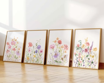 May include: Four framed watercolour paintings of floral bouquets with pink, orange, and purple flowers. The paintings are in gold frames and are arranged in a row on a wooden floor.