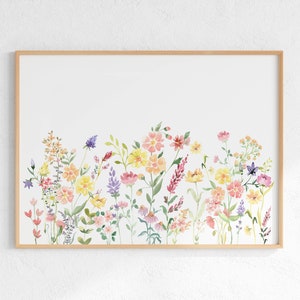May include: A watercolor painting of a field of wildflowers in shades of pink, yellow, and purple. The flowers are arranged in a horizontal row across the bottom of the image, with a white background.
