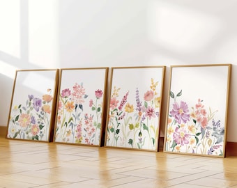 May include: Four framed watercolour paintings of floral arrangements in shades of pink, purple, yellow, and orange. The paintings are arranged in a row on a wooden floor.