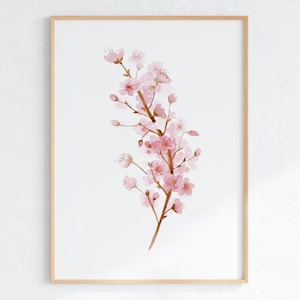 May include: A watercolor painting of a pink cherry blossom branch with delicate petals and brown stems. The painting is framed in a light wood frame.