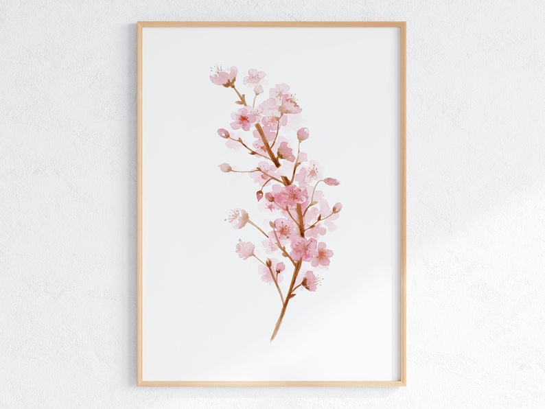 May include: A watercolor painting of a pink cherry blossom branch with delicate petals and brown stems. The painting is framed in a light wood frame.