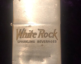 May include: Silver lighter with the words "White Rock Sparkling Beverages" engraved on the front.