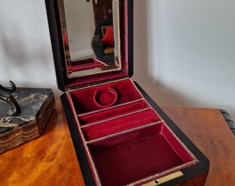 May include: An antique wooden jewellery box with a red velvet interior and a small mirror in the lid. The box has a keyhole and a key.