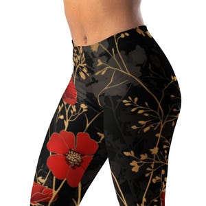 May include: Leggings featuring a black base color with a repeating pattern of vibrant red flowers and thin, golden-yellow stems and branches. The design covers the entire surface of the fabric, showcasing a contrast between the dark background and the floral elements.