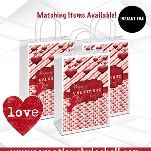 May include: Three white gift bags with red and pink striped patterns and hearts. The bags have handles and are decorated with the text "Happy Valentine's Day!" and a cupid with an arrow. The bags are on a white surface. The text "love" is in a red heart shape in the lower left corner of the image.