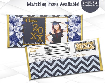 May include: A blue and gold graduation party favor chocolate bar wrapper with a photo of a graduate in a cap and gown. The wrapper features a chevron pattern, the text "Class of 20XX", and the words "The tassel was worth the hassel".