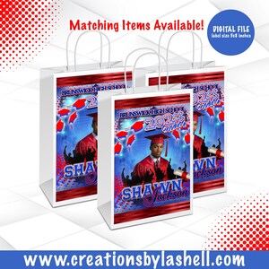 May include: Three white gift bags with blue and red graduation themed designs. The bags feature a photo of a graduate in a cap and gown, the text "Brunswick High School 2023 Graduate", and the name "Shawn Jackson".