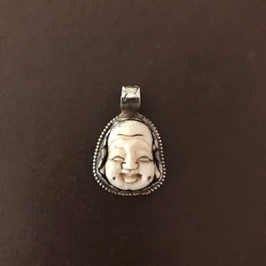 Happy buddha face bone pendant, handcrafted , Nepalese, Tibetan repousse silver, Himalayan
