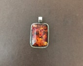 Tibetan resin pendant, handcrafted, Nepalese, Himalayan, repousse silver, floral back