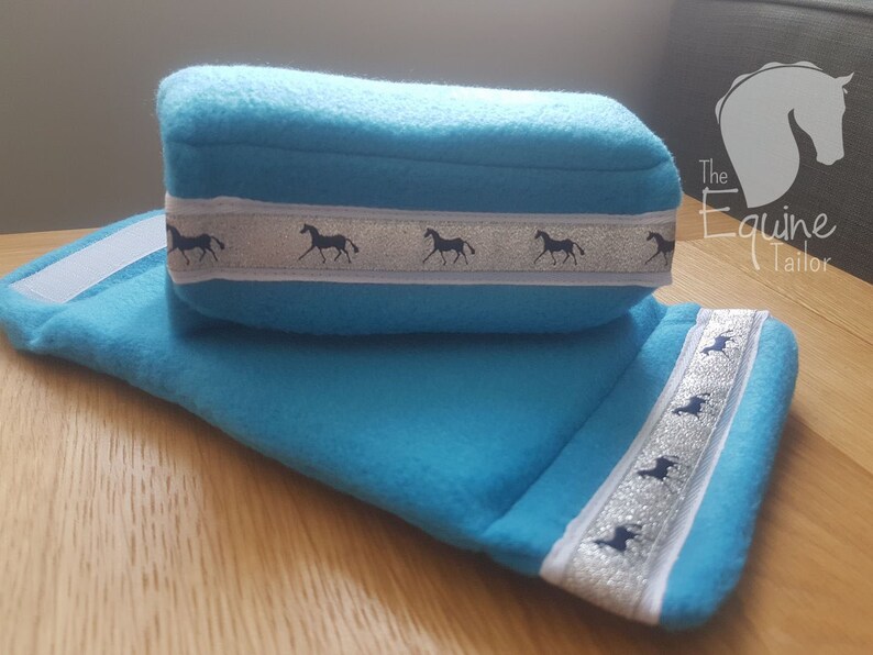 Aqua polar fleece with silver horse ribbon trim Stirrup Bumpers Stirrup covers.