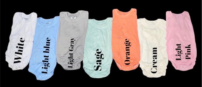 May include: Eight baby onesies in different colors, including white, light blue, light gray, sage, orange, cream, and light pink. Each onesie has a different color and a text label with the color name.