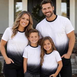May include: A set of matching short-sleeve t-shirts featuring a white to black ombre gradient design. Each shirt has a solid black crew neckline and a straight hem. The gradient pattern transitions from white at the top to a solid black at the bottom.