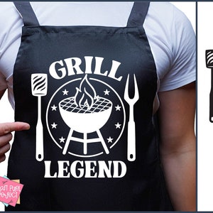 May include: Black and white graphic design of a grill with flames, a spatula, and a grill fork. The text "Grill Legend" is displayed below the grill. The design is on a black apron.