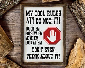 May include: A white sign with black text and a red stop sign with a white hand print. The sign reads "My Tool Rules,  ATY Do Not: TI, Touch 'Em, Borrow 'Em, Move 'Em, Look At 'Em, Don't Even Think About It!"