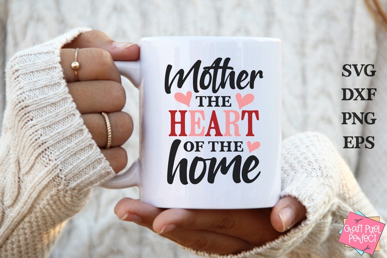 May include: White ceramic mug with black text that reads "Mother the heart of the home" with pink hearts.