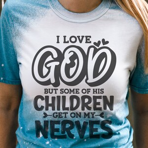 May include: A white t-shirt with a black graphic that says "I love God but some of his children get on my nerves".
