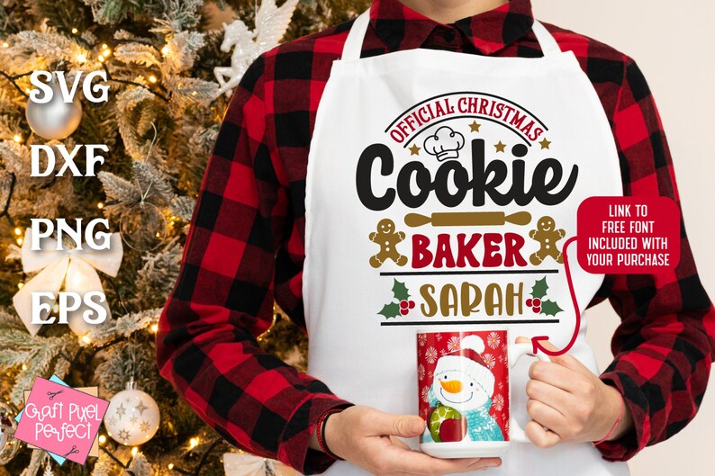 May include: White Christmas-themed apron with the text "Official Christmas Cookie Baker Sarah" in red, gold, and black lettering. A gingerbread man graphic is on either side of the text. A red mug with a snowman graphic is in the lower right corner.