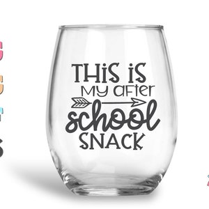 May include: A clear glass wine glass with the text "This is my after school snack" printed on it. The text is in black and includes a small arrow graphic.