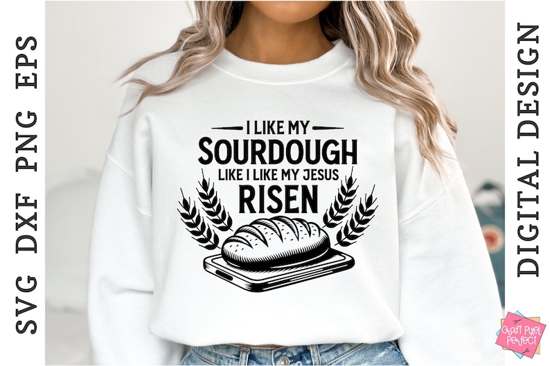 May include: A white sweatshirt with a black graphic design that says "I like my sourdough like I like my Jesus risen". The graphic also includes a loaf of bread and wheat stalks.