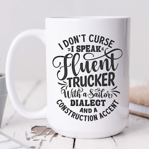 May include: White ceramic mug with a black design that reads "I don't curse - I speak fluent trucker with a sailor dialect and a construction accent".