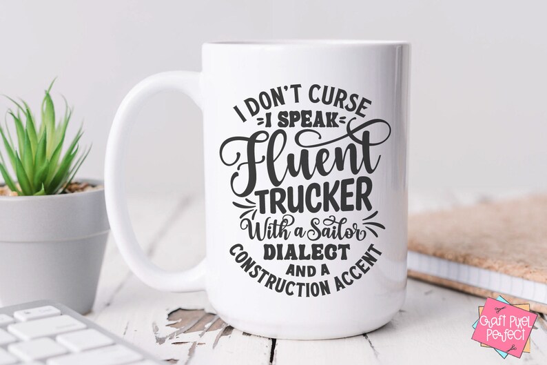 May include: White ceramic mug with a black design that reads "I don't curse - I speak fluent trucker with a sailor dialect and a construction accent".