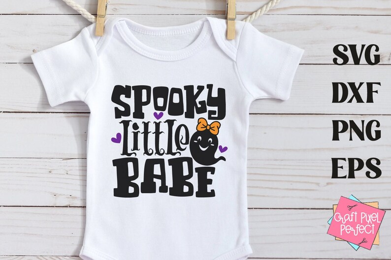 May include: White baby onesie with the text "Spooky Little Babe" in black with a purple heart and a ghost with an orange bow.
