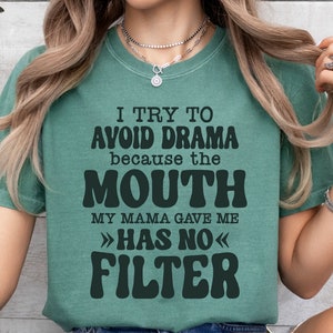 May include: A teal green t-shirt with the text "I try to avoid drama because the mouth my mama gave me >>has no<< filter" in black.