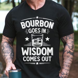 May include: A black t-shirt with white text that reads "Bourbon goes in Wisdom comes out". The shirt features a stylized image of a glass of bourbon with ice cubes.
