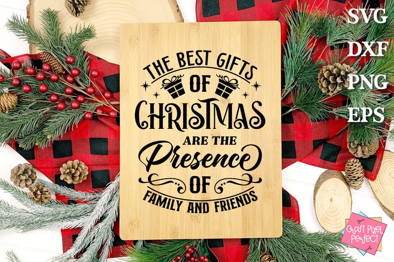 May include: A wooden cutting board with the text "The Best Gifts of Christmas Are The Presence of Family and Friends" in black lettering.