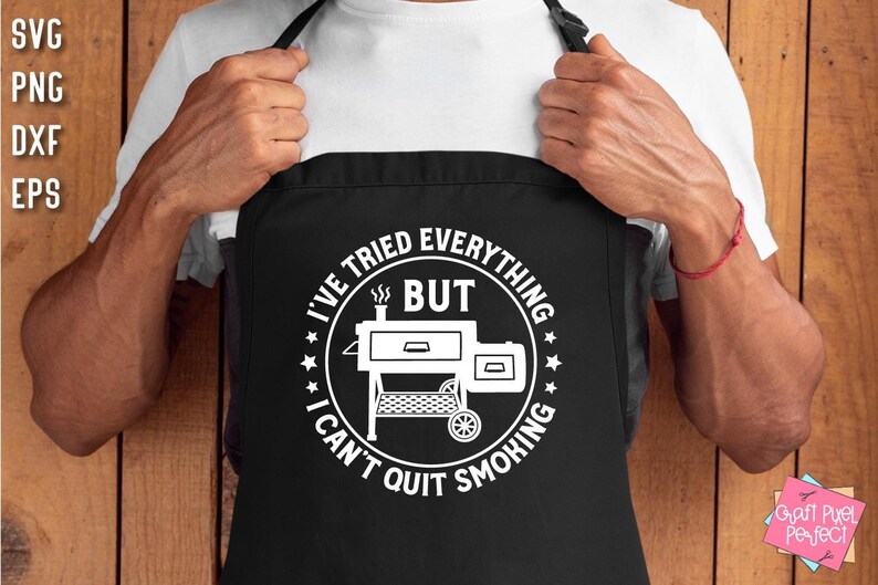 May include: Black apron with a white circle design featuring a smoker grill and the text "I've tried everything but I can't quit smoking".