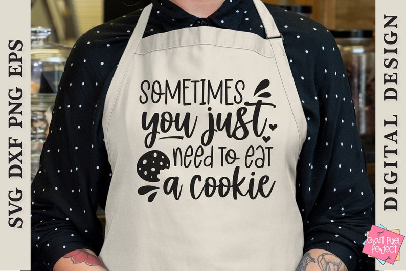 May include: A white apron with black text that reads "Sometimes you just need to eat a cookie". A black and white cookie graphic is included in the text.