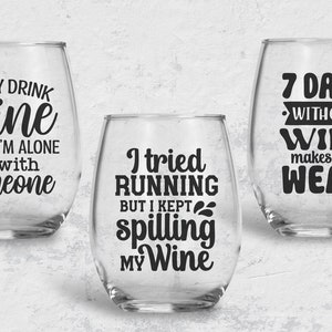 May include: Three clear glass wine glasses with black vinyl lettering. The glasses feature humorous sayings about wine. The first glass says "I only drink wine when I'm alone or with someone". The second glass says "I tried running but I kept spilling my wine". The third glass says "7 days without wine makes one weak".