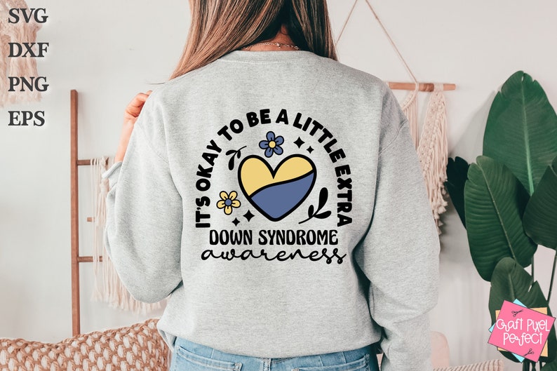 May include: A gray sweatshirt with a yellow and blue heart design and the text "It's okay to be a little extra Down Syndrome awareness".