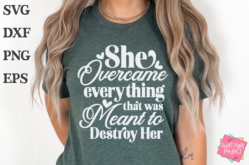 May include: A green t-shirt with the text "She overcame everything that was meant to destroy her" in white lettering with hearts.